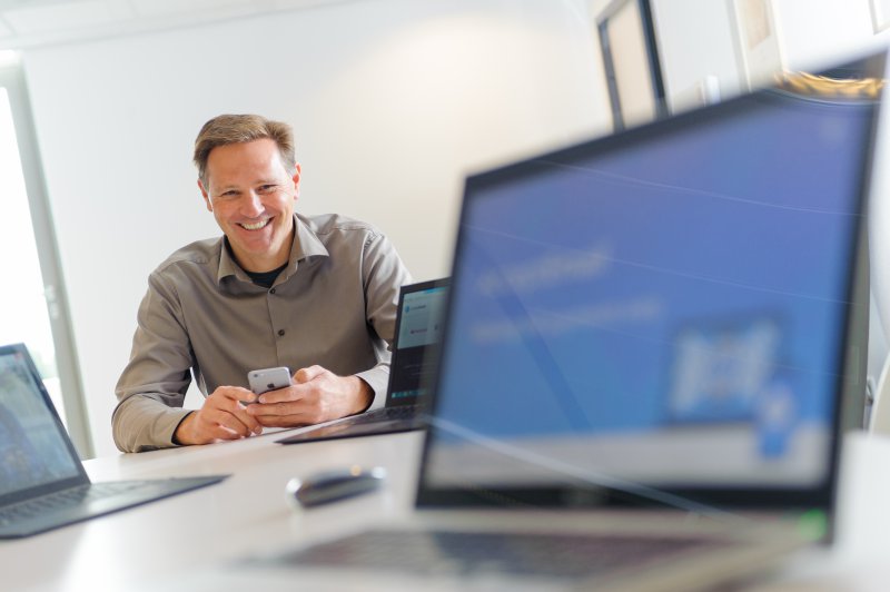 smiling man and laptop screen